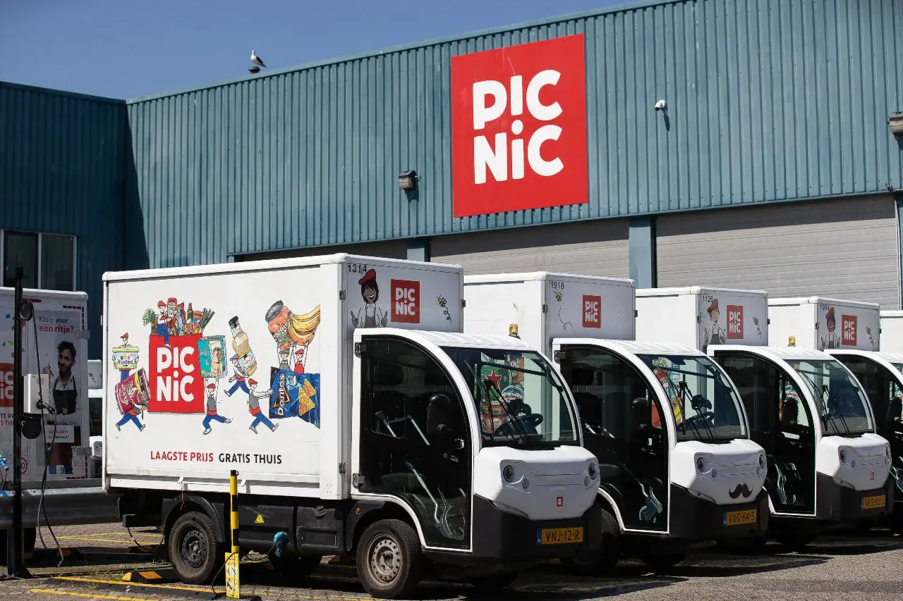 A Picnic electric delivery vehicle parked outside a depot